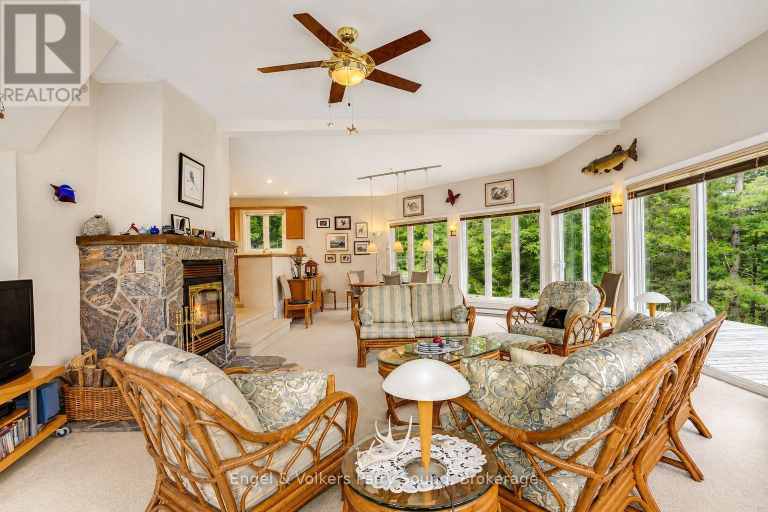 1 Loon Bay, Carling, ON - Indoor Photo Showing Living Room With Fireplace