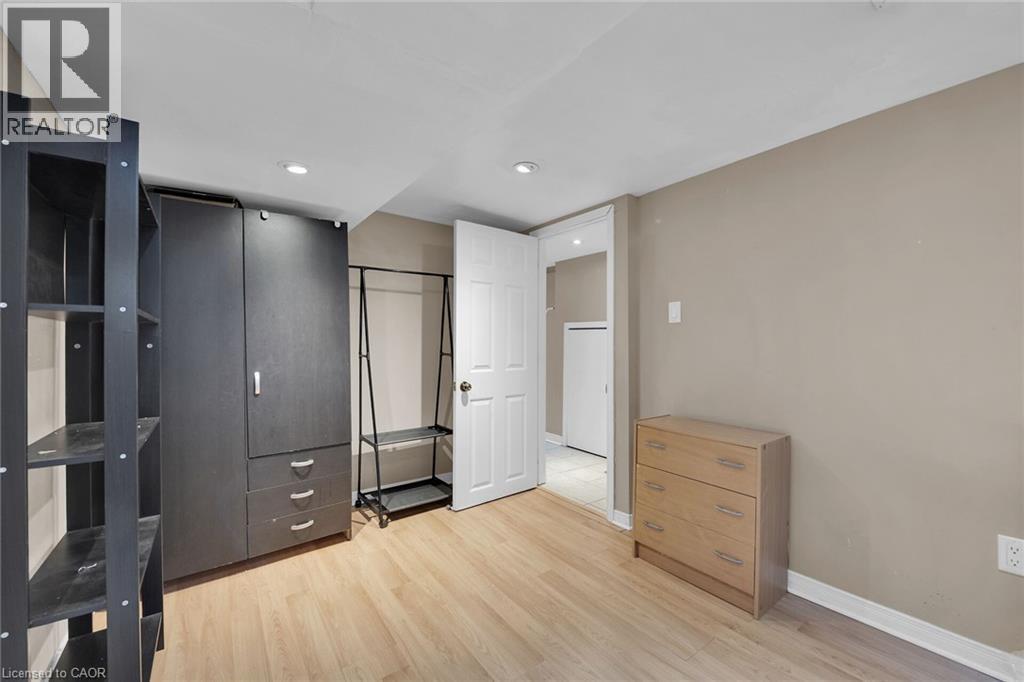 Neutral-toned walls complement the wood-finish flooring - 738 King Street W, Hamilton, ON - Indoor Photo Showing Other Room