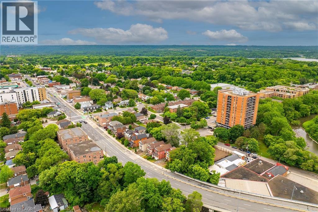 Aerial perspective showcasing a mixed-use neighborhood with residential and commercial structures - 738 King Street W, Hamilton, ON - Outdoor With View