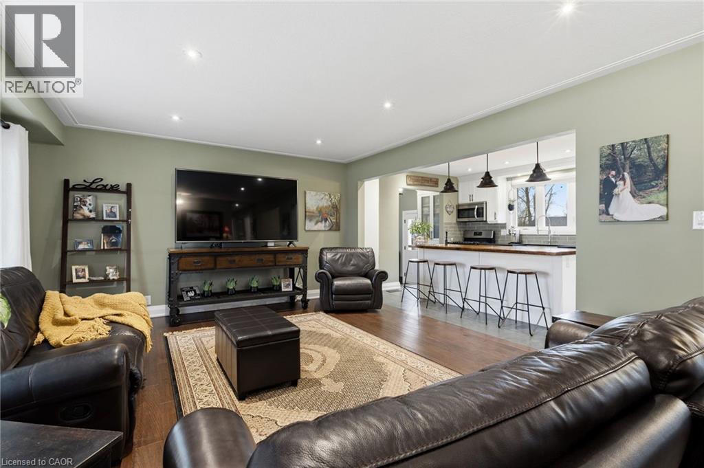 Open-concept living area featuring hardwood flooring, recessed lighting, and crown molding - 2116 Binbrook Road E, Hamilton, ON - Indoor Photo Showing Living Room