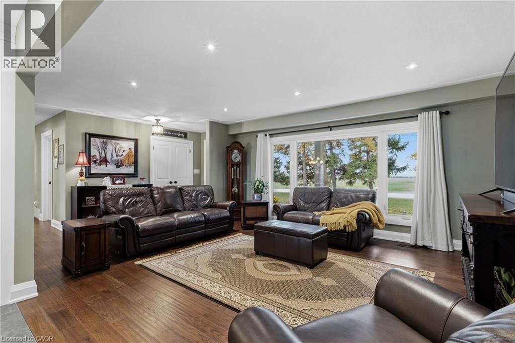 Spacious living area featuring wood-finish flooring, recessed lighting, and a large picture window with outdoor scenery - 2116 Binbrook Road E, Hamilton, ON - Indoor Photo Showing Living Room