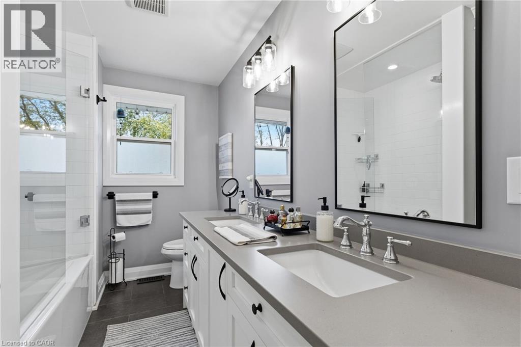 Dual basin vanity with undermount sinks and contemporary chrome fixtures - 2116 Binbrook Road E, Hamilton, ON - Indoor Photo Showing Bathroom