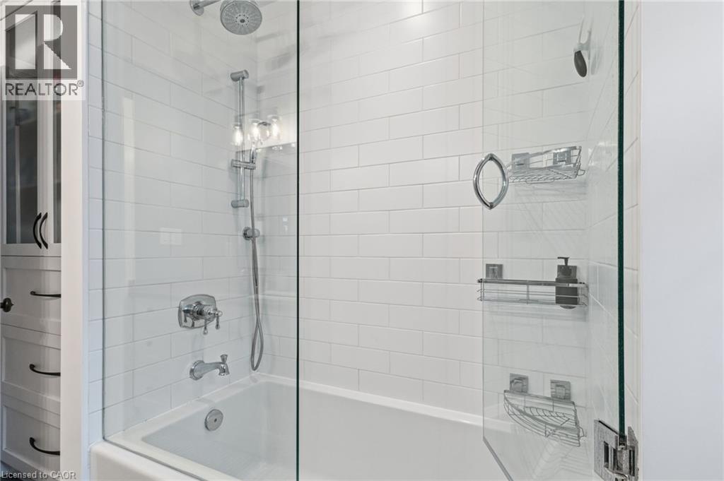 Subway tile surround with a built-in bathtub and glass shower enclosure - 2116 Binbrook Road E, Hamilton, ON - Indoor Photo Showing Bathroom
