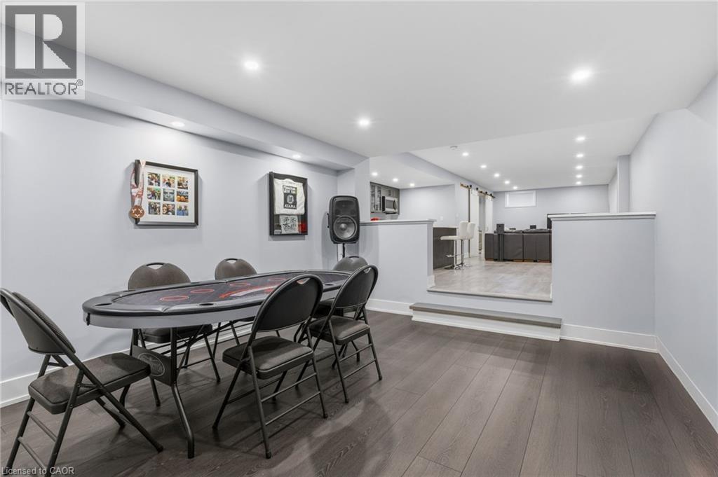 Lower level featuring wood-finish flooring, recessed lighting, and a half-wall partition - 2116 Binbrook Road E, Hamilton, ON - Indoor Photo Showing Dining Room