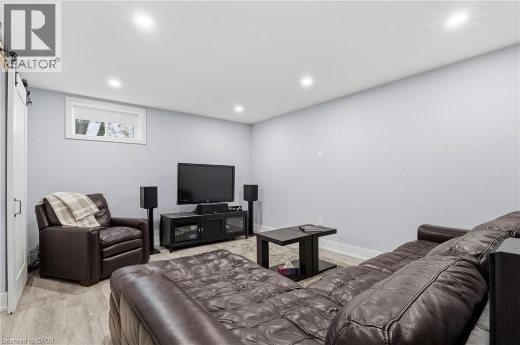 Finished lower level featuring recessed lighting, light gray wall paint, and wood-finish flooring - 2116 Binbrook Road E, Hamilton, ON - Indoor Photo Showing Other Room