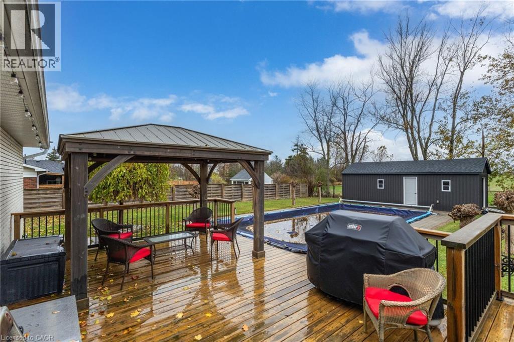 Expansive wood-finish deck with a built-in gazebo and metal roof - 2116 Binbrook Road E, Hamilton, ON - Outdoor With Deck Patio Veranda