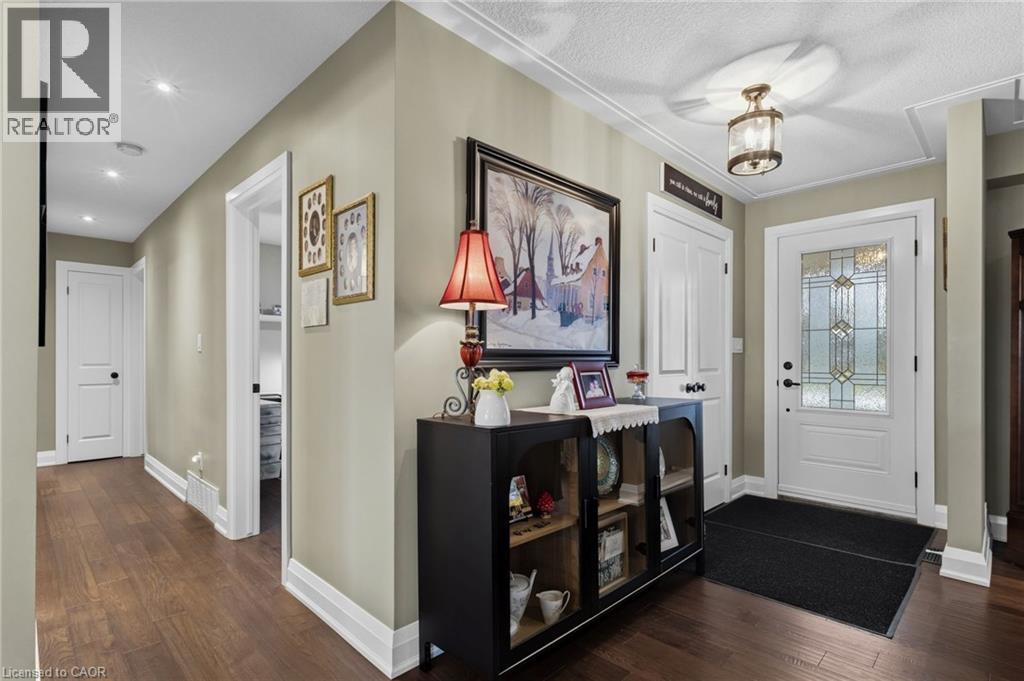 Entryway featuring a decorative transom window, wood-finish flooring, recessed lighting, crown molding, and a built-in ceiling fixture - 2116 Binbrook Road E, Hamilton, ON - Indoor Photo Showing Other Room