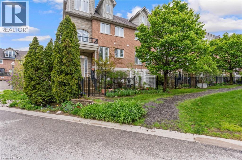 Townhome exterior featuring a stone and brick facade - 53 Grosvenor Lane, Cambridge, ON - Outdoor