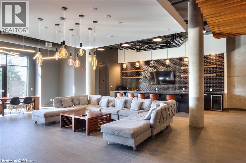 Open-concept lounge. - 247 Northfield Drive E Unit# 207, Waterloo, ON - Indoor Photo Showing Living Room With Fireplace