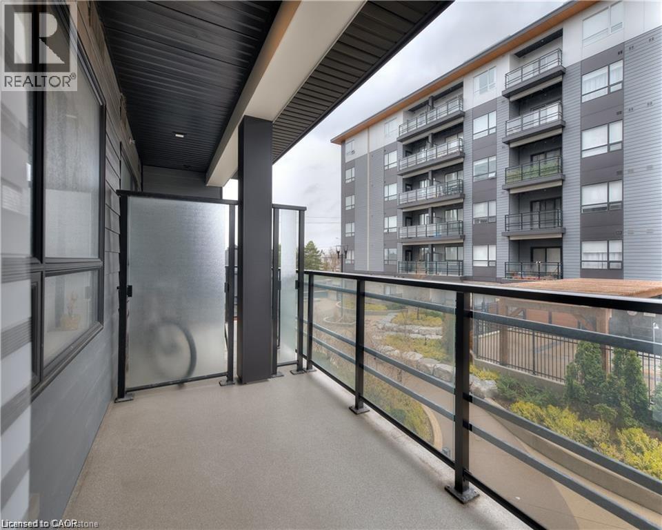 Private balcony featuring a glass railing system and durable composite flooring - 247 Northfield Drive E Unit# 207, Waterloo, ON - Outdoor With Balcony With Exterior