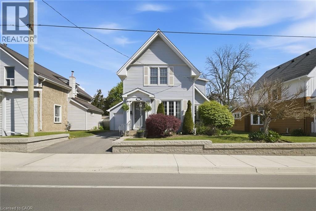 Gable-roof home featuring light-colored siding and a covered front entry - 401 West Street, Simcoe, ON - Outdoor With Facade