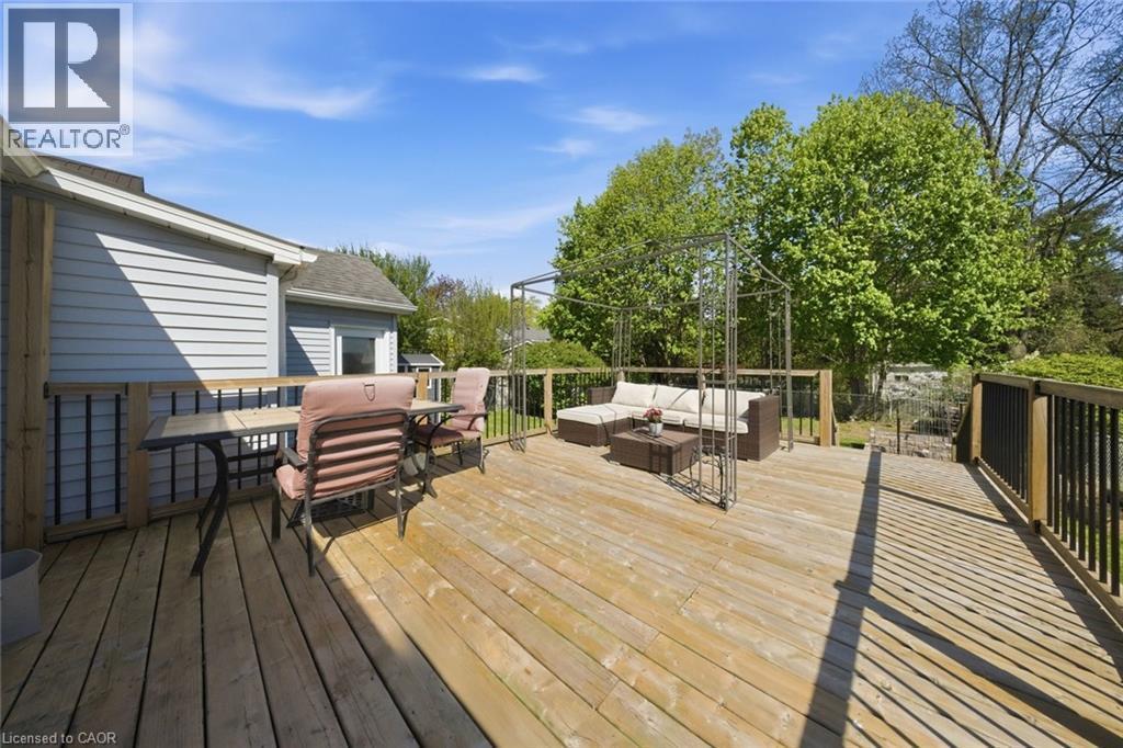 Expansive wood deck with wood plank flooring and dark wood railings - 401 West Street, Simcoe, ON - Outdoor With Deck Patio Veranda With Exterior