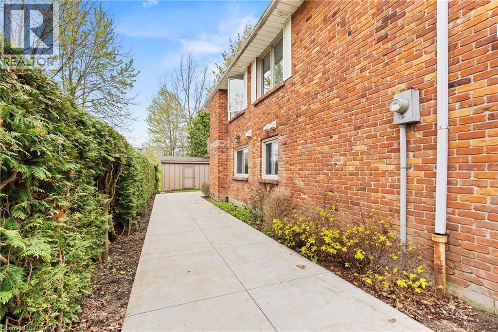 Brick exterior with multiple windows and a concrete pathway - 3 San Pedro Drive, Hamilton, ON - Outdoor