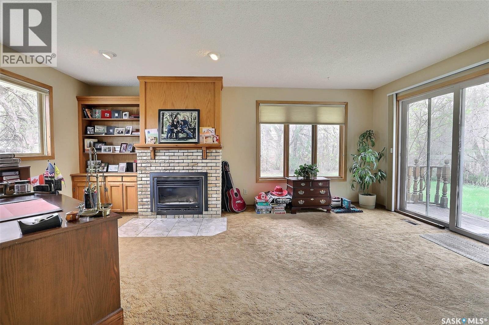 15 Academy Park Road, Regina, SK - Indoor Photo Showing Living Room With Fireplace