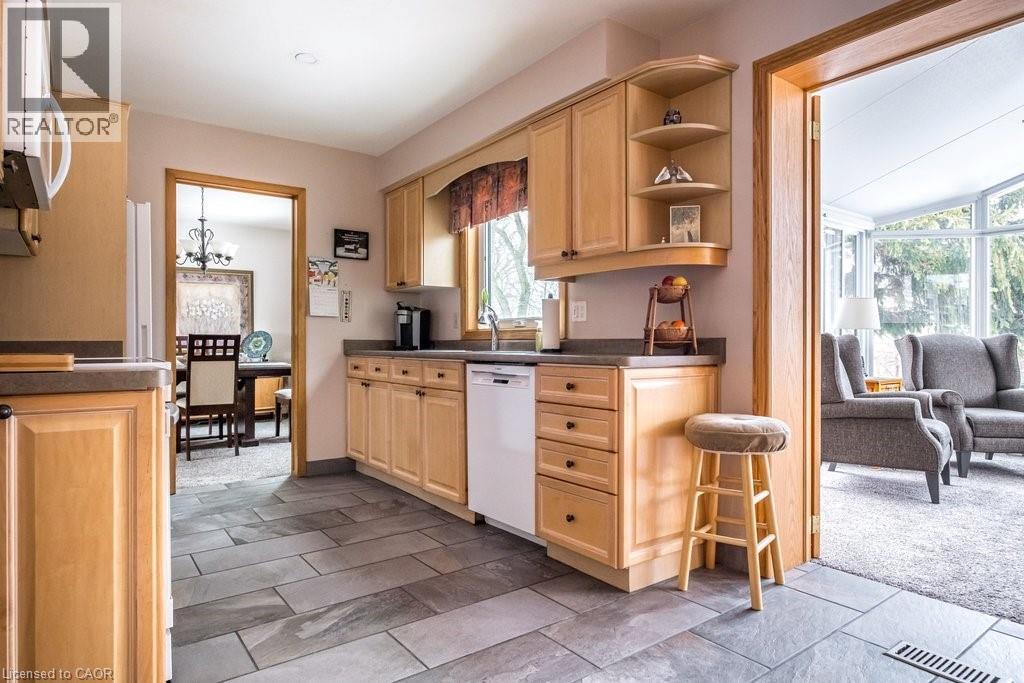 Kitchen featuring light wood cabinetry, a built-in dishwasher, and slate-style tile flooring - 19 Chateau Court, Hamilton, ON - Indoor Photo Showing Kitchen