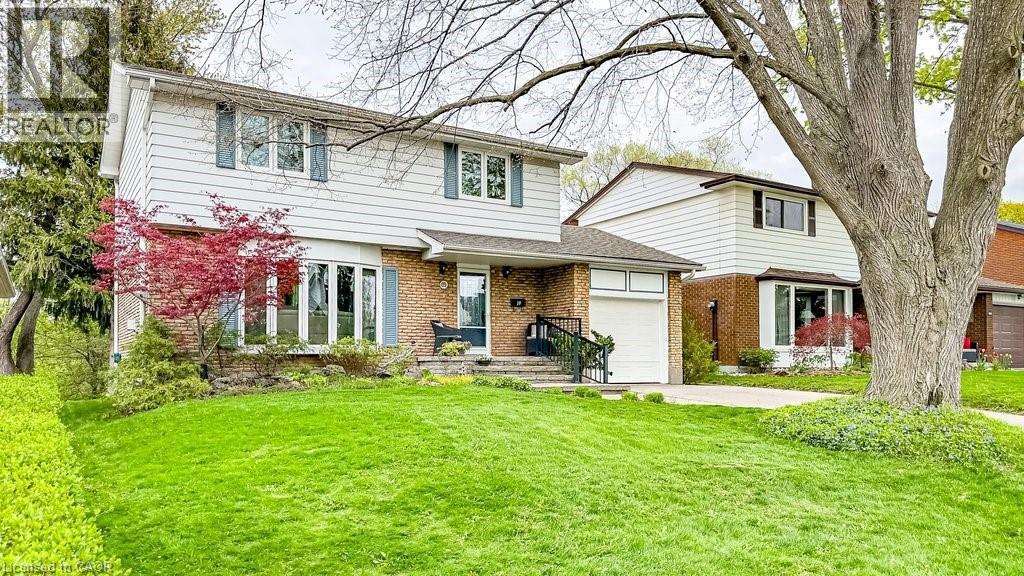 Two-story residence featuring a white horizontal siding exterior with contrasting blue window shutters and brick accents - 19 Chateau Court, Hamilton, ON - Outdoor