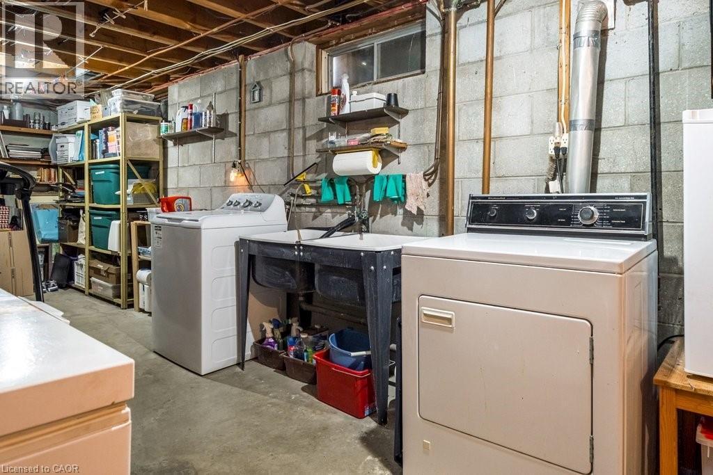 Lower-level utility area featuring exposed joists, block foundation walls, and a concrete floor - 19 Chateau Court, Hamilton, ON - Indoor Photo Showing Laundry Room