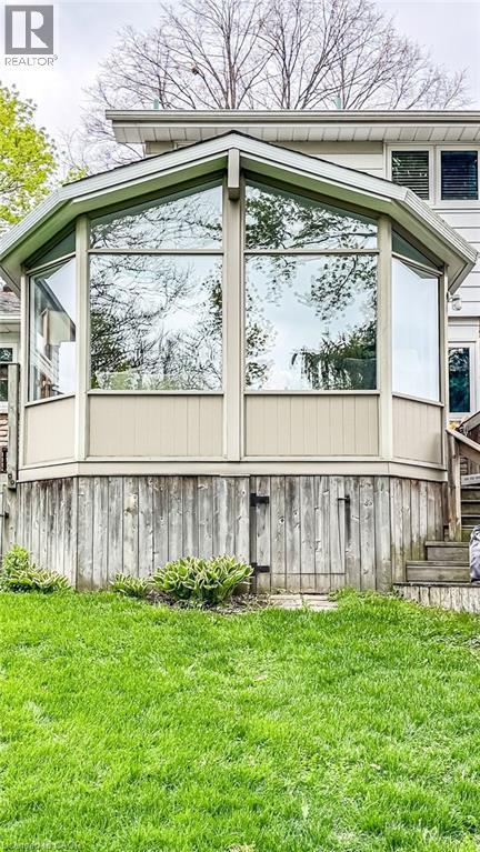 Exterior sunroom addition featuring large, clear windows and neutral-toned paneling - 19 Chateau Court, Hamilton, ON - Outdoor