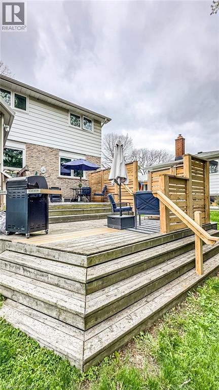 Multi-level wooden deck featuring integrated privacy screens and a handrail - 19 Chateau Court, Hamilton, ON - Outdoor With Deck Patio Veranda