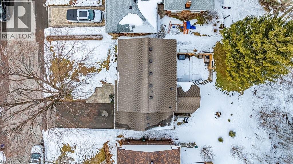 Aerial perspective showcasing the property's shingled roof, paved driveway, and established tree canopy - 19 Chateau Court, Hamilton, ON - Outdoor