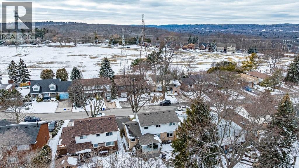 Aerial perspective of a residential street with homes featuring pitched roofs and varied exterior finishes - 19 Chateau Court, Hamilton, ON - Outdoor With View
