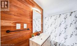 Wood-finish accent wall with integrated mirror and vanity lighting -