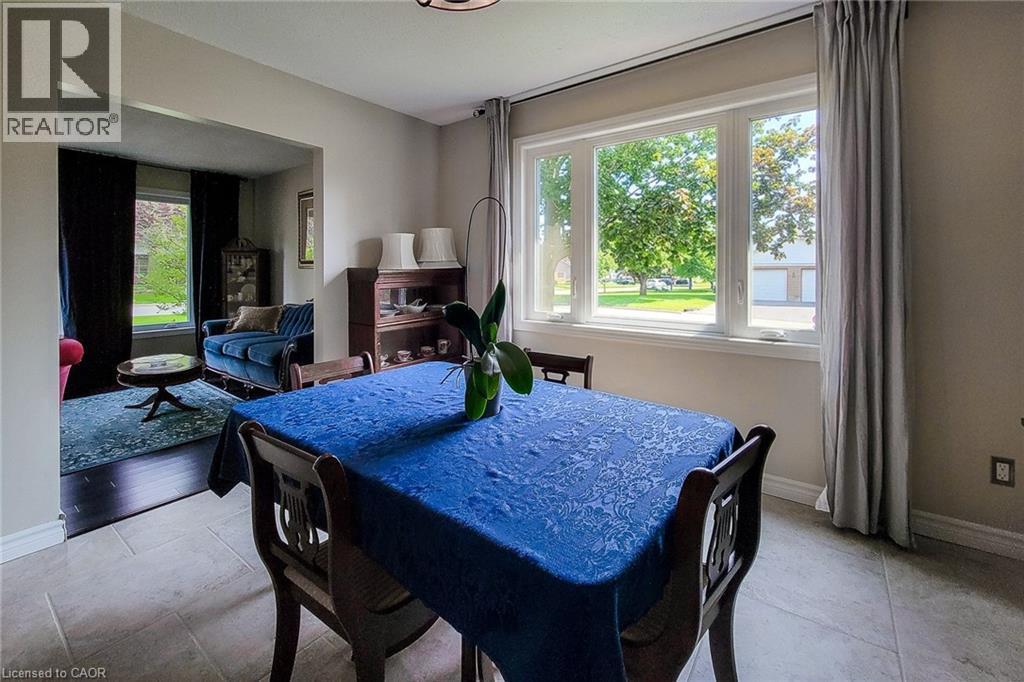 Dining area with tiled flooring and a large multi-pane window - 49 Ashwood Drive, Cambridge, ON - Indoor