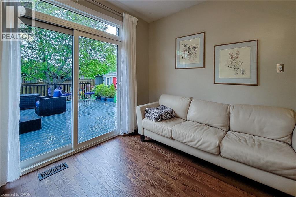 Sliding glass door opening to an outdoor deck - 49 Ashwood Drive, Cambridge, ON - Indoor Photo Showing Living Room