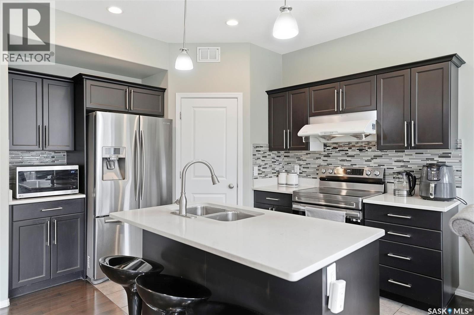 519 Rempel Manor, Saskatoon, SK - Indoor Photo Showing Kitchen With Stainless Steel Kitchen With Double Sink With Upgraded Kitchen