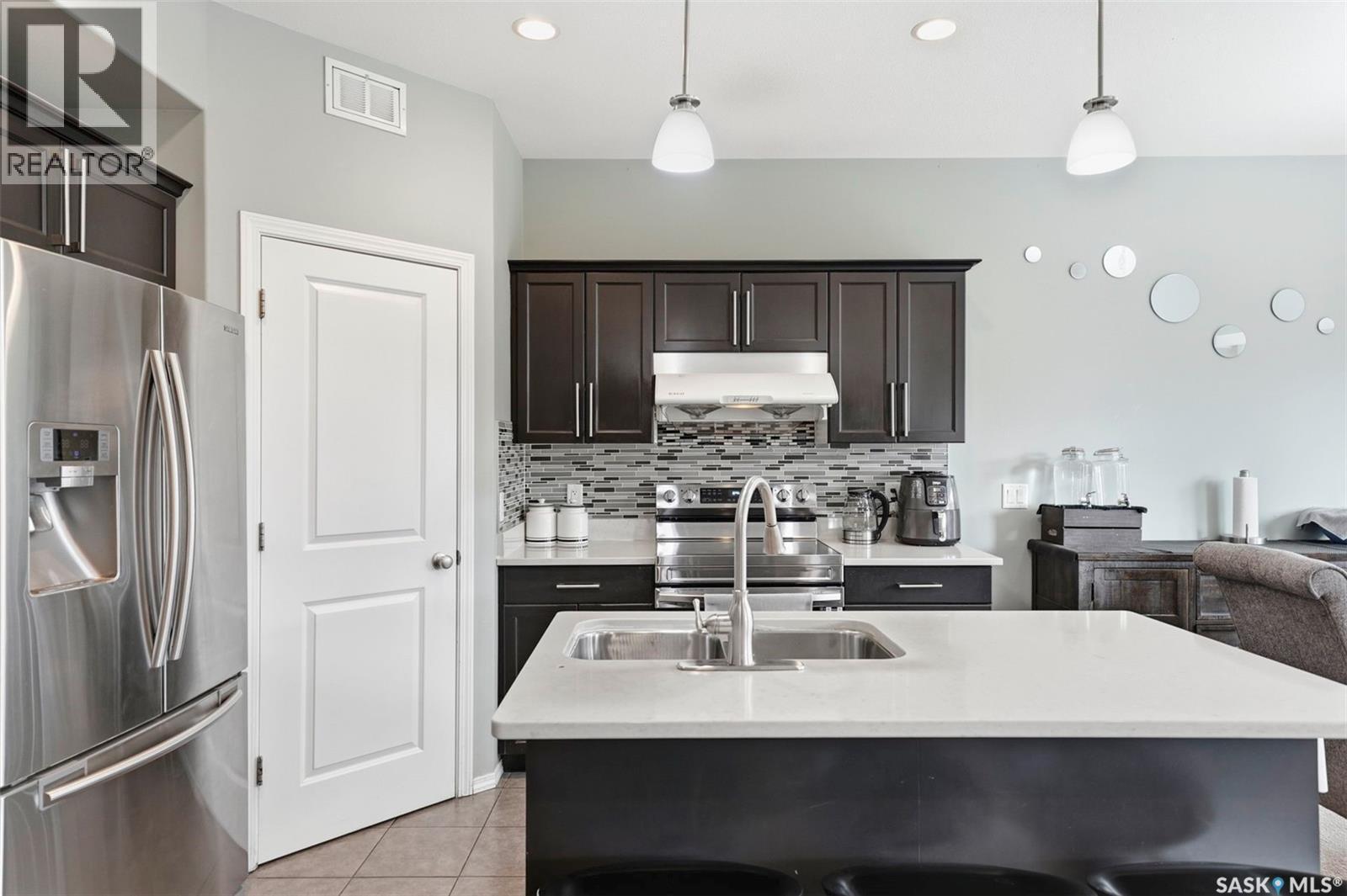 519 Rempel Manor, Saskatoon, SK - Indoor Photo Showing Kitchen With Stainless Steel Kitchen With Double Sink With Upgraded Kitchen