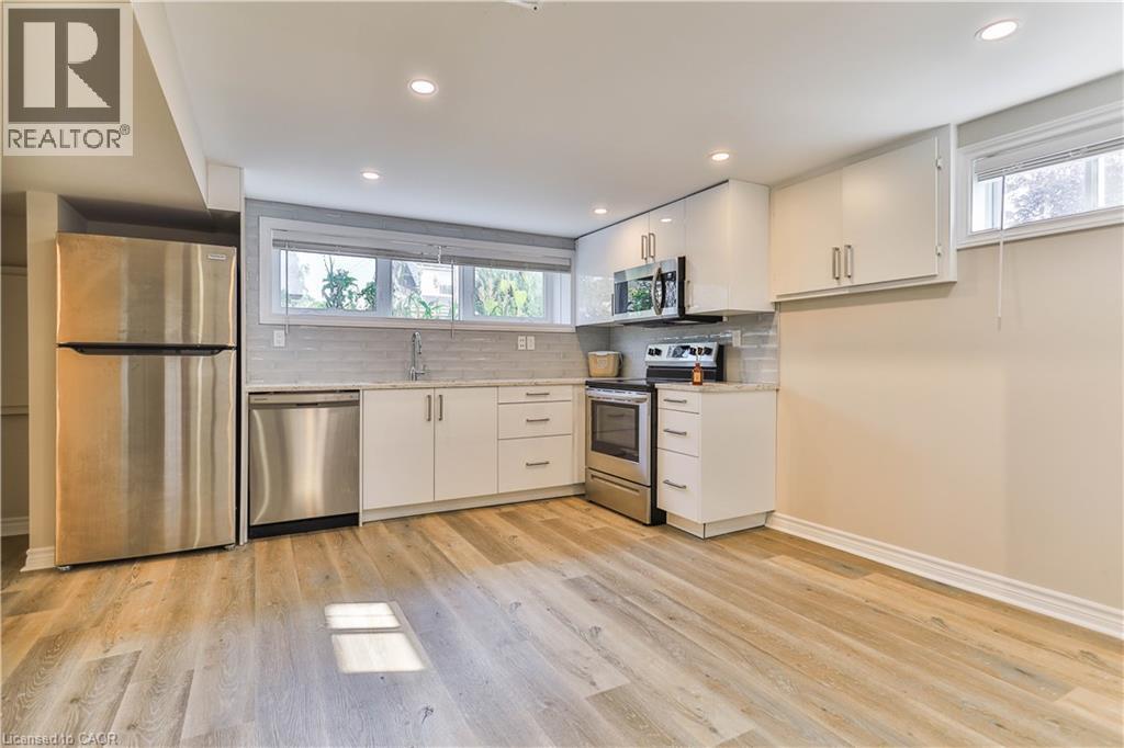 Kitchen featuring white cabinetry, stainless steel appliances, a tiled backsplash, and recessed lighting - 38 Dunkirk Drive Unit# B, Hamilton, ON - Indoor Photo Showing Kitchen With Stainless Steel Kitchen
