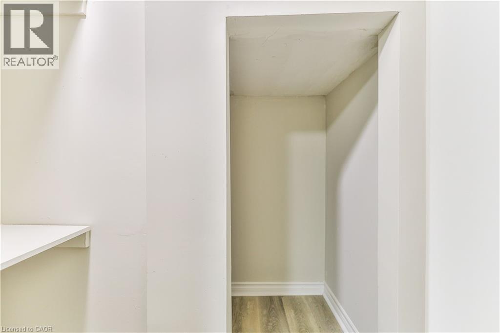 Recessed alcove featuring wood-finish flooring and white baseboards - 38 Dunkirk Drive Unit# B, Hamilton, ON - Indoor Photo Showing Other Room