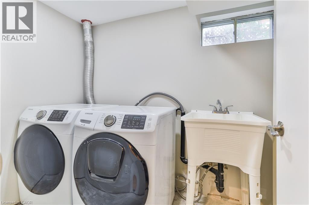 Dedicated laundry area featuring a utility sink, a window, and light-colored walls - 38 Dunkirk Drive Unit# B, Hamilton, ON - Indoor Photo Showing Laundry Room