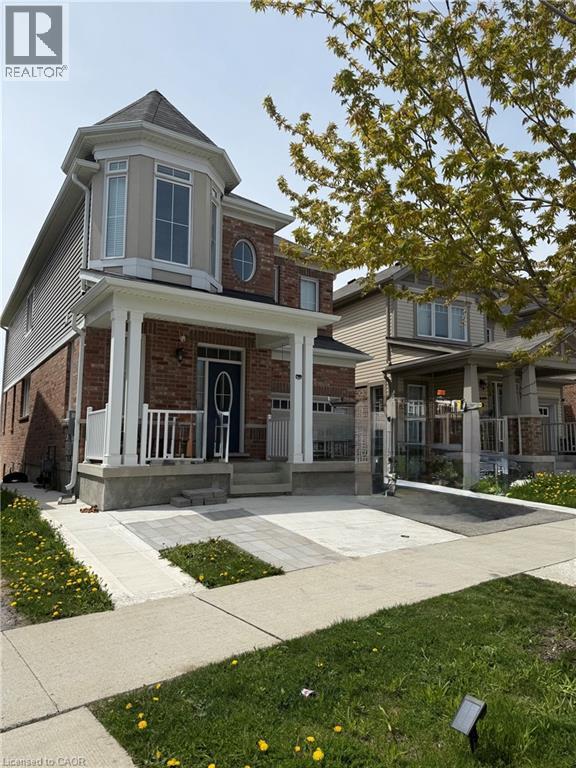 Brick and siding exterior featuring a prominent bay window with a turret-style roofline - 63 Ridge Road Unit# Upper, Cambridge, ON - Outdoor With Facade