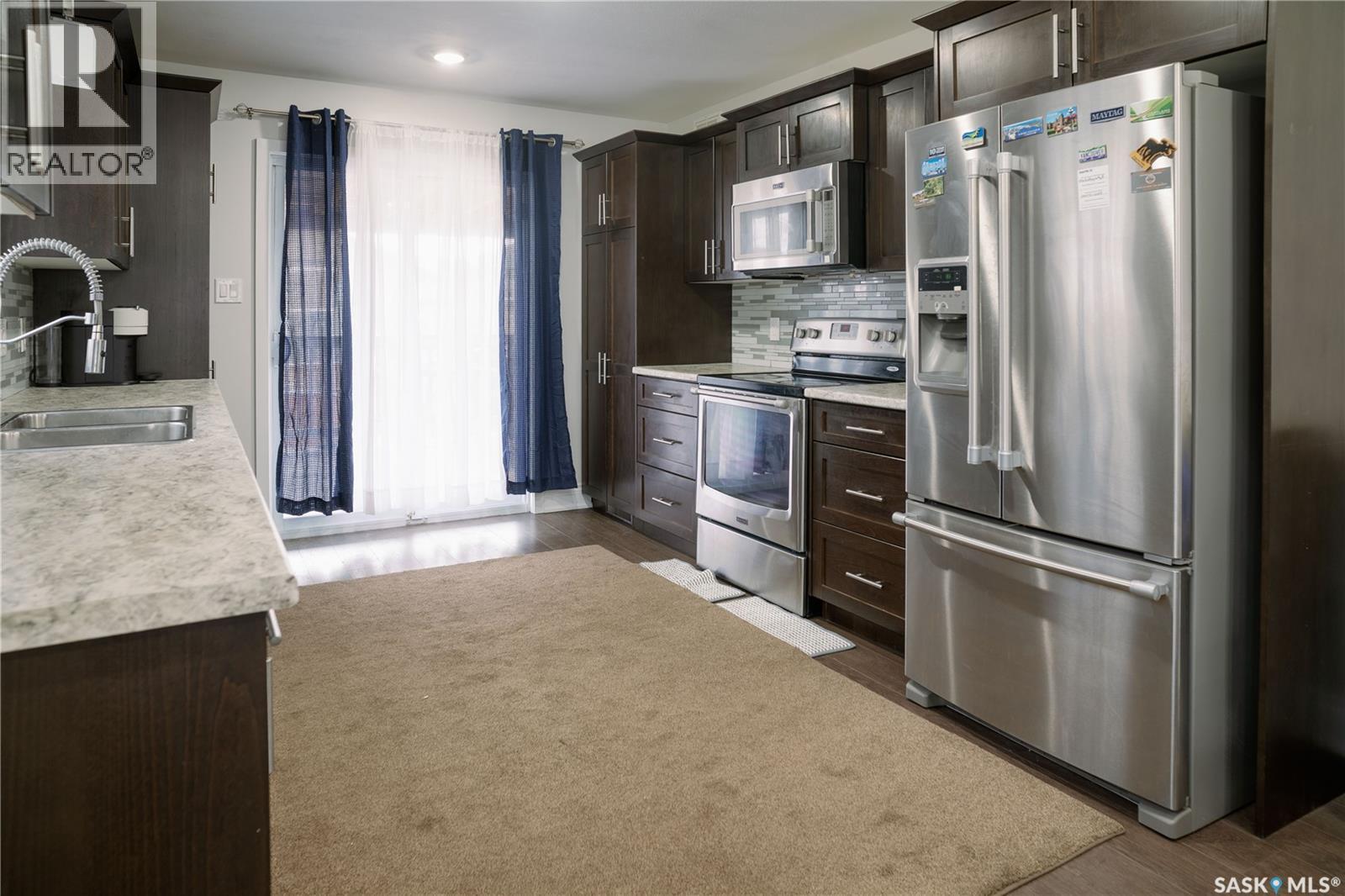 205 Reddekopp Lane, Warman, SK - Indoor Photo Showing Kitchen With Double Sink