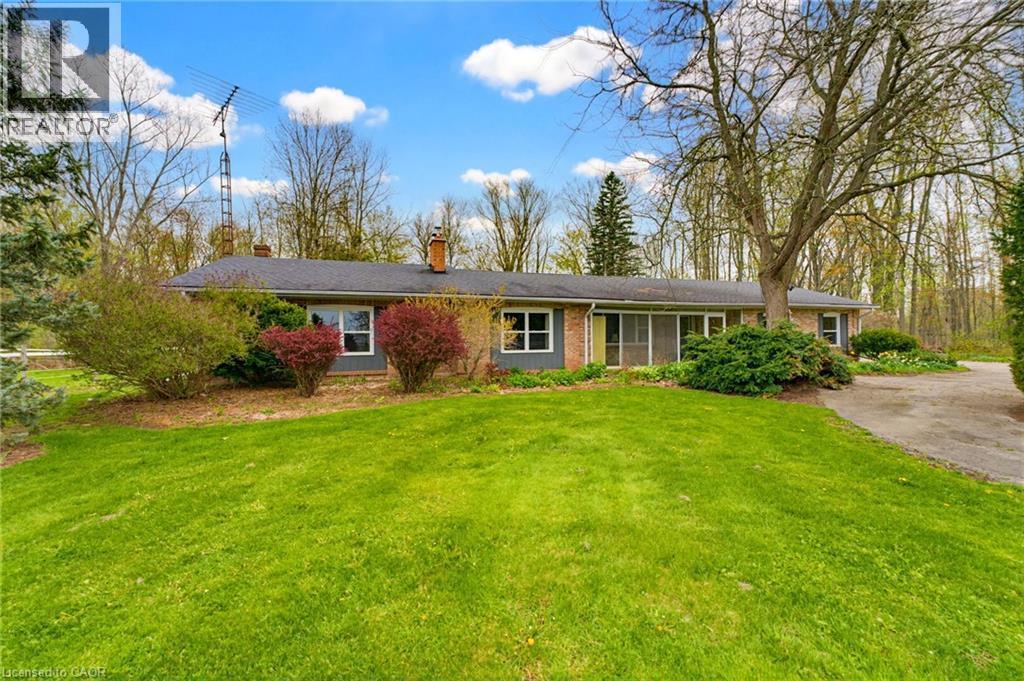 Brick ranch-style residence featuring a dark shingle roof and multiple chimneys - 10 Huisman Lane, Hamilton, ON
