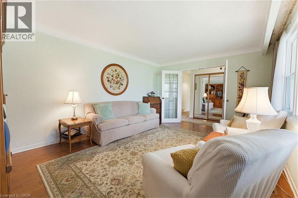 Light-filled interior featuring wood-finish flooring, a neutral color palette, and white trim - 10 Huisman Lane, Hamilton, ON