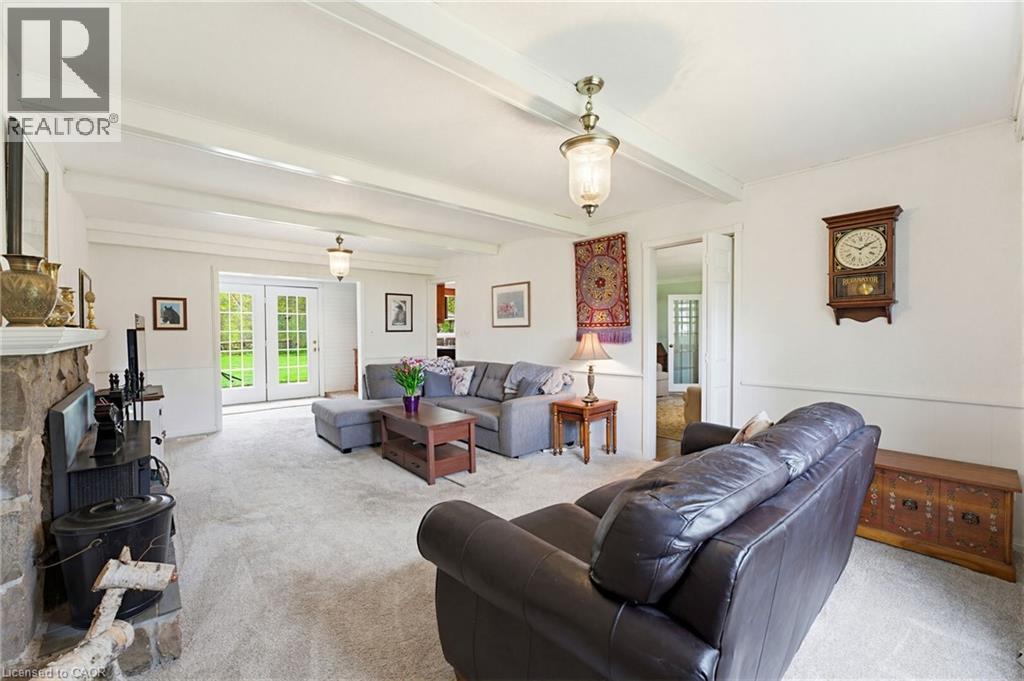 Living room featuring exposed ceiling beams and light-toned carpeting - 10 Huisman Lane, Hamilton, ON