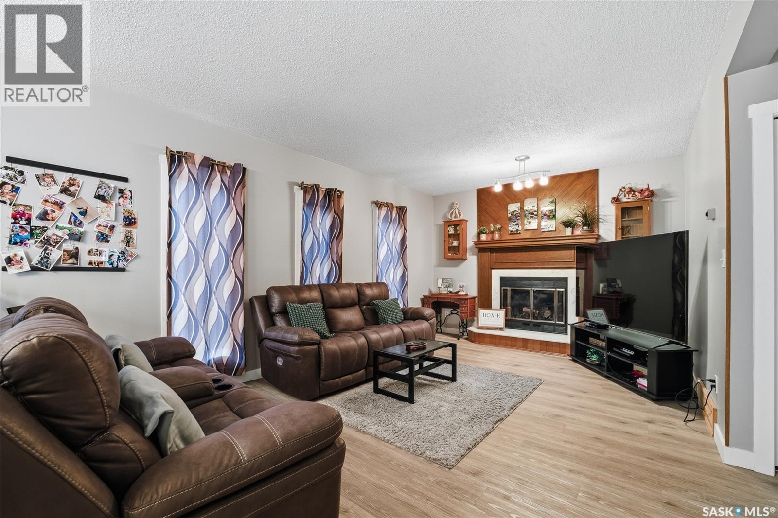 6962 Maple Brook Crescent, Regina, SK - Indoor Photo Showing Living Room With Fireplace