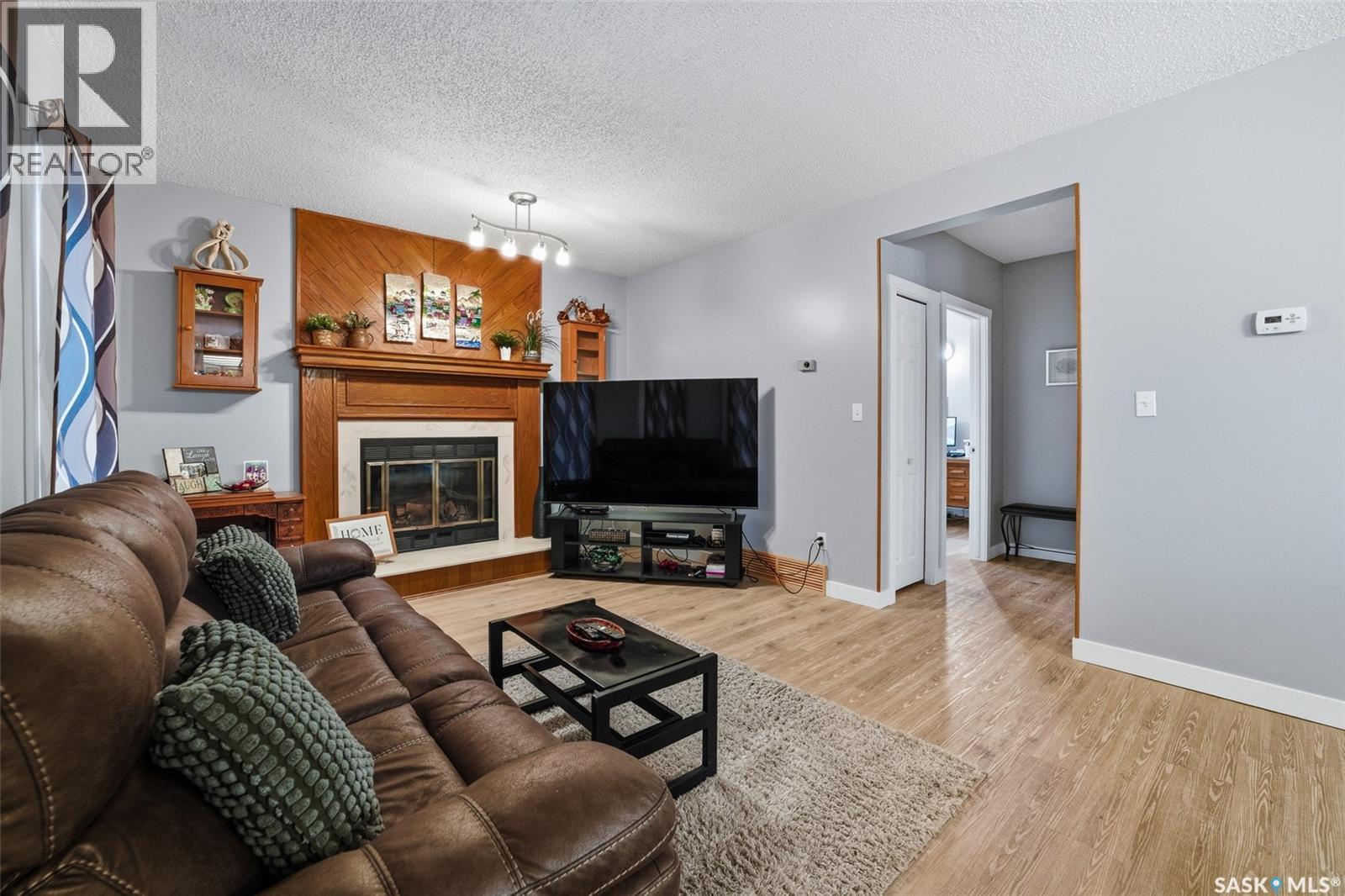 6962 Maple Brook Crescent, Regina, SK - Indoor Photo Showing Living Room With Fireplace