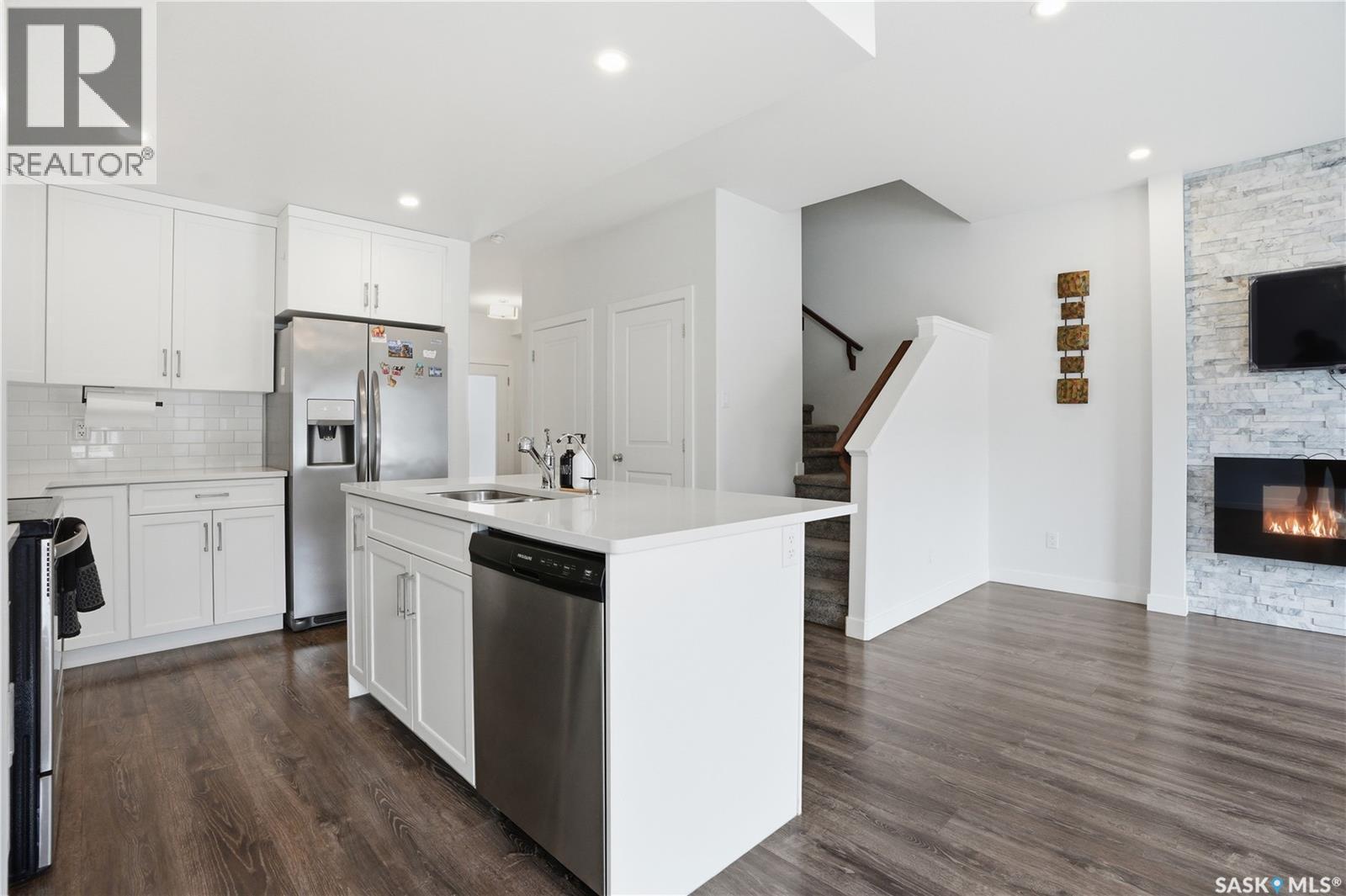 234 Brighton Gate, Saskatoon, SK - Indoor Photo Showing Kitchen With Fireplace With Stainless Steel Kitchen