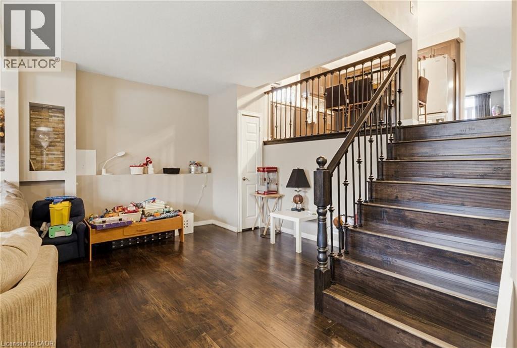 Dark wood-finish flooring throughout the main level - 47 Hannah Crescent, Hamilton, ON - Indoor Photo Showing Other Room