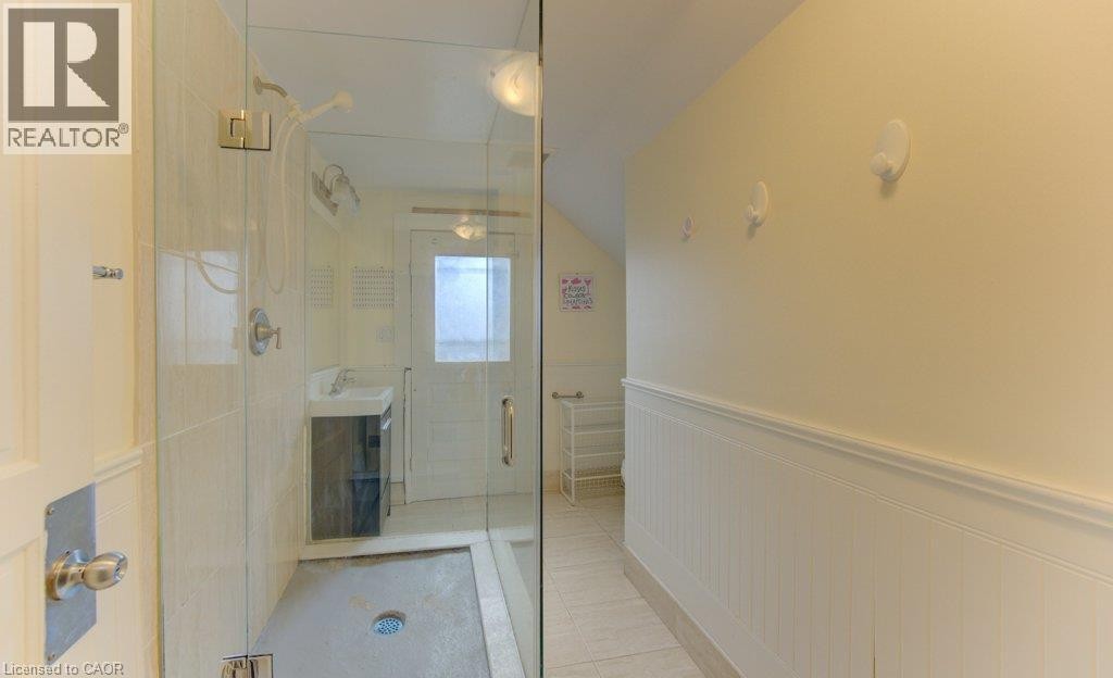Glass-enclosed shower with tile surround and rain showerhead - 10 Marshall Street, Waterloo, ON