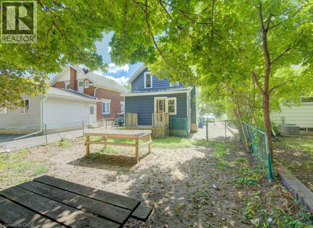 Rear exterior with a wooden deck and a chain link fence - 10 Marshall Street, Waterloo, ON