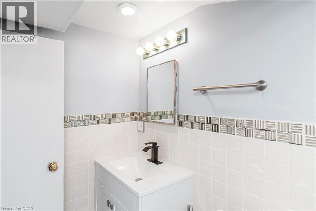 Vanity with integrated sink and matte black faucet - 112 Nash Road S, Hamilton, ON - Indoor Photo Showing Bathroom