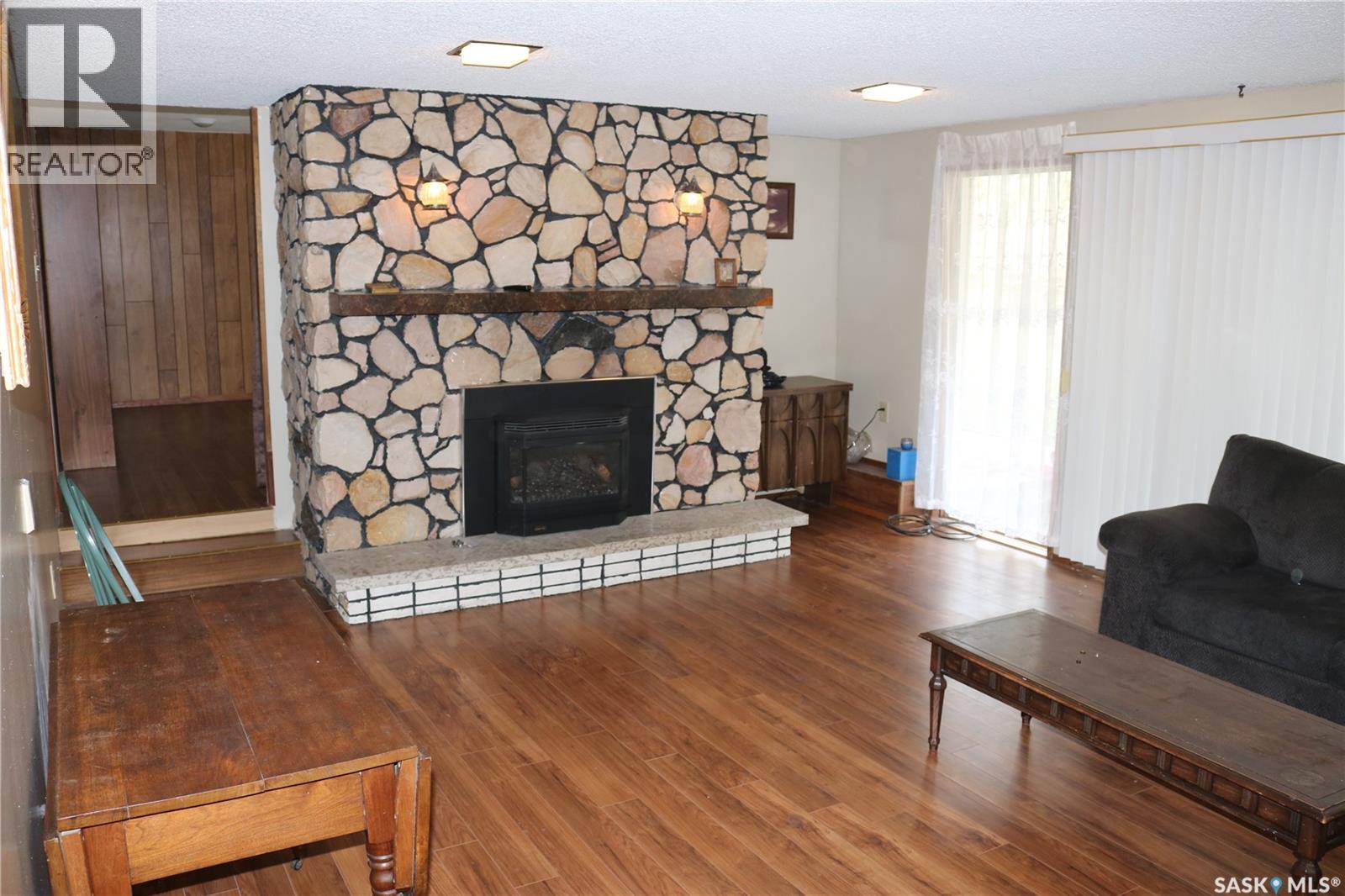 211 Pipestone Avenue, Wawota, SK - Indoor Photo Showing Living Room With Fireplace