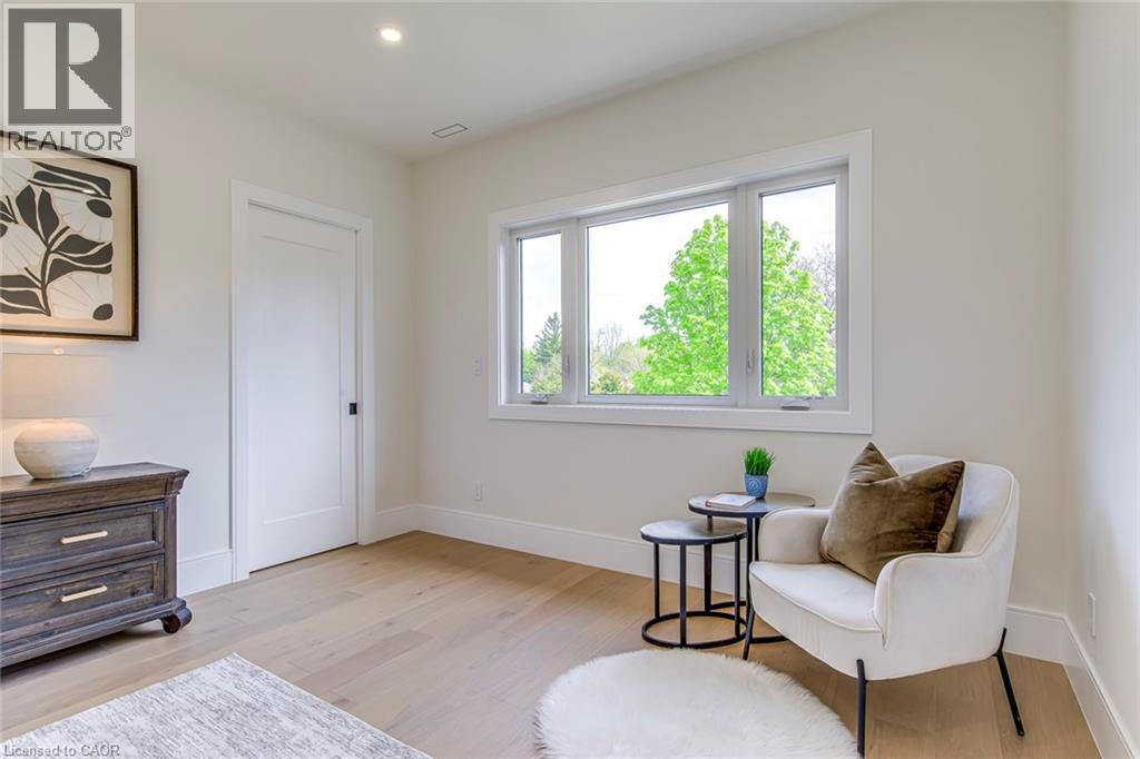 Bright room with light wood-finish flooring, recessed lighting, and a large window providing abundant natural light - 1411 Mountain Grove Avenue, Burlington, ON - Indoor Photo Showing Other Room