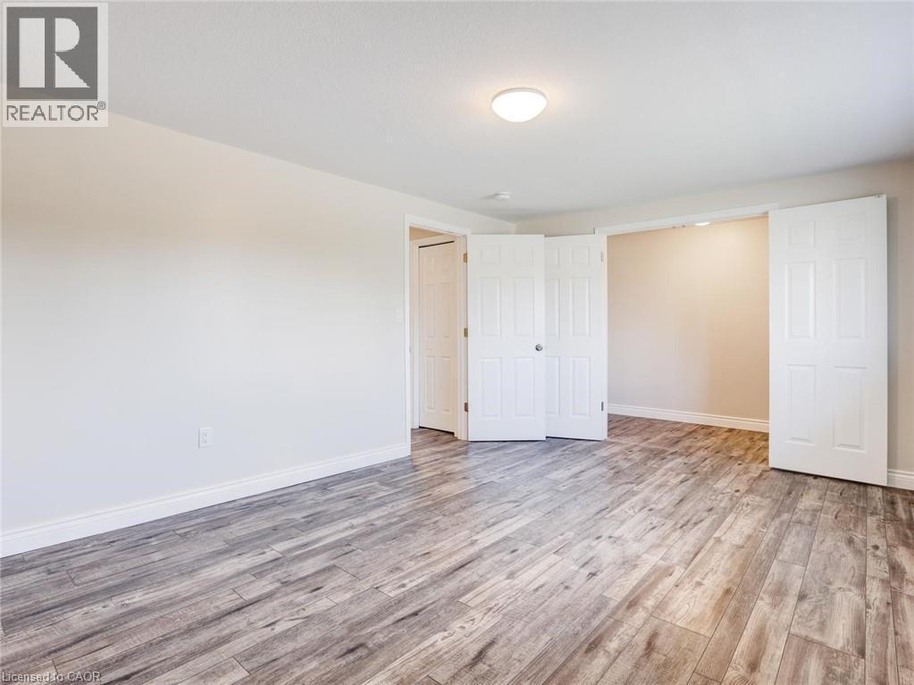 Spacious room featuring light wood-finish flooring and neutral wall tones - 833 Doon Village Road, Kitchener, ON - Indoor Photo Showing Other Room