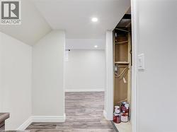 Wood-finish flooring throughout, complemented by crisp white walls and recessed ceiling lighting -