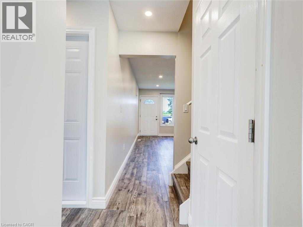Entryway featuring wood-finish flooring, recessed lighting, and a white paneled door - 833 Doon Village Road, Kitchener, ON - Indoor Photo Showing Other Room